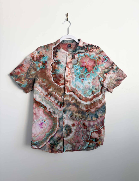 M geode tie dye button down shirt in turquoise, rust, and brown hanging on a white hanger