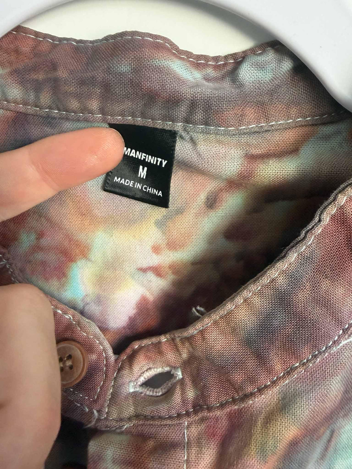 Manfinity size M tag inside a turquoise and rust ice dyed button down shirt collar