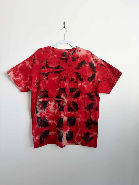 XL red and black tie dye t-shirt with bold crystal pattern hanging on a white hanger